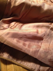 In a well-made coat, the lining isn't completely sewn down at the bottom. It allows it to lay nicely. (This isn't needed in a jacket/blazer, however.)