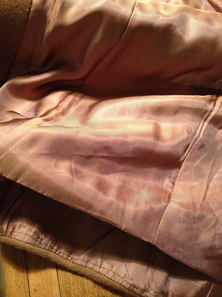 In a well-made coat, the lining isn't completely sewn down at the bottom. It allows it to lay nicely. (This isn't needed in a jacket/blazer, however.)